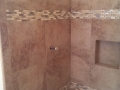 Water pipe in tile shower being remodeled by All Vees general contractors